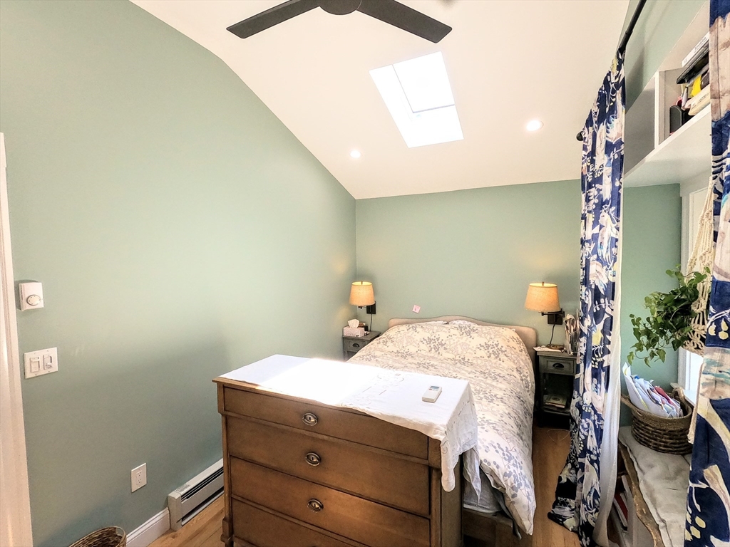 12 Searle Road, Unit 12 Boston, MA 02132 - Photo 33 of 35 a bedroom with a bed and a potted plant