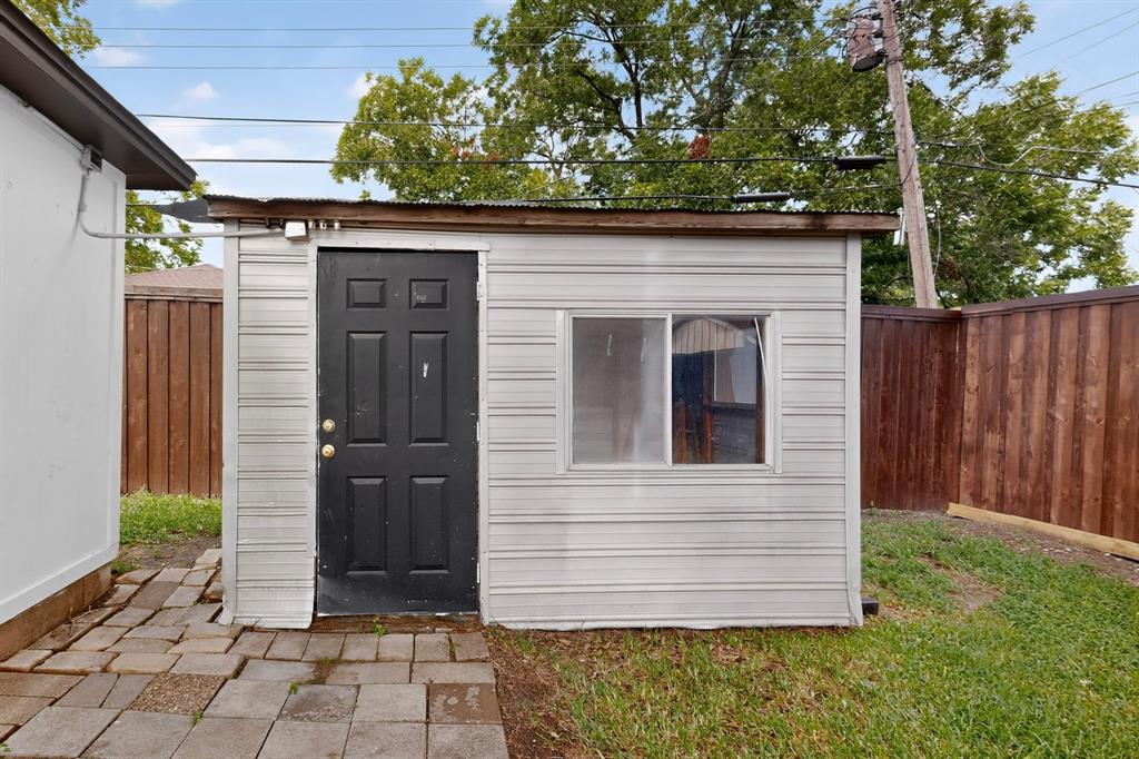 4404 Astor Road Mesquite, TX 75150 - Photo 37 of 38 Detached shed featuring light-colored siding, a dark panel door, and a single window