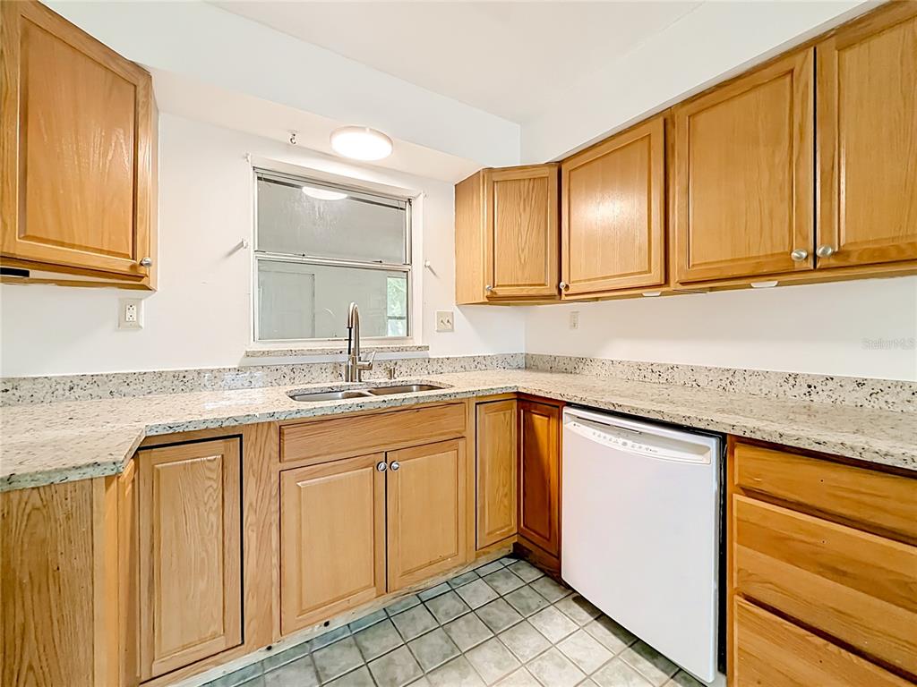3 Bahia Pl Loop Ocala, FL 34472 - Photo 11 of 31 a kitchen with granite countertop cabinets sink and white appliances