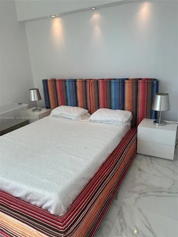 a view of a livingroom with furniture and a mirror