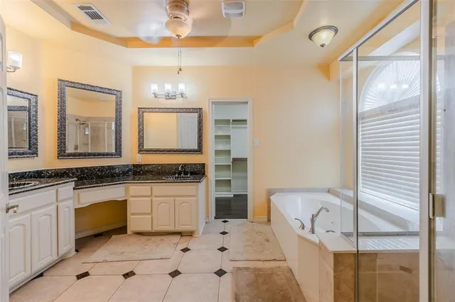 a bathroom with a tub sink and mirror