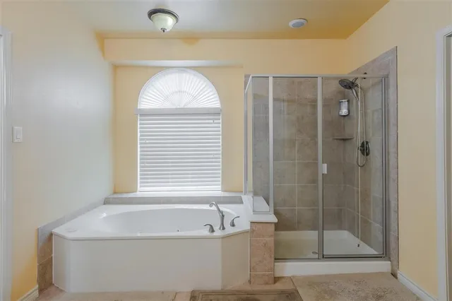 a bathroom with a bathtub and shower