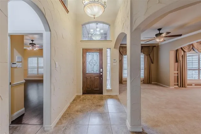 wooden floor with a chandelier and a mirror
