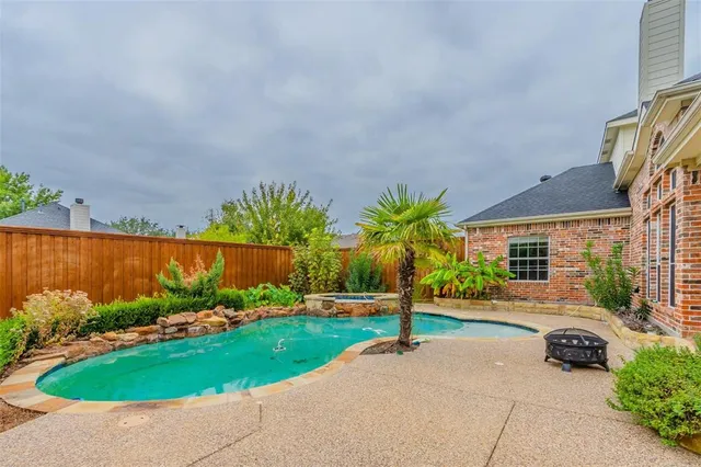 a front view of a house with a garden and plants