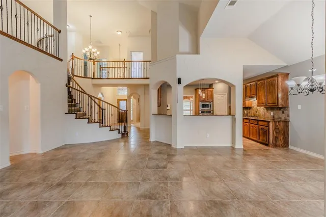 a view of a kitchen with furniture and staircase