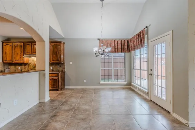 a view of an empty room with a kitchen