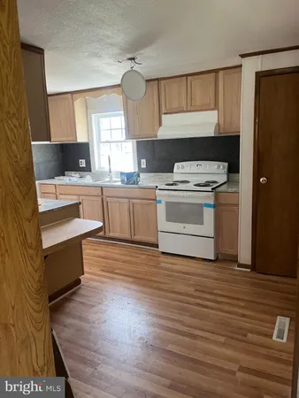 a kitchen with a stove a sink and a refrigerator