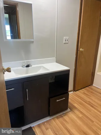 a bedroom with a sink and a mirror