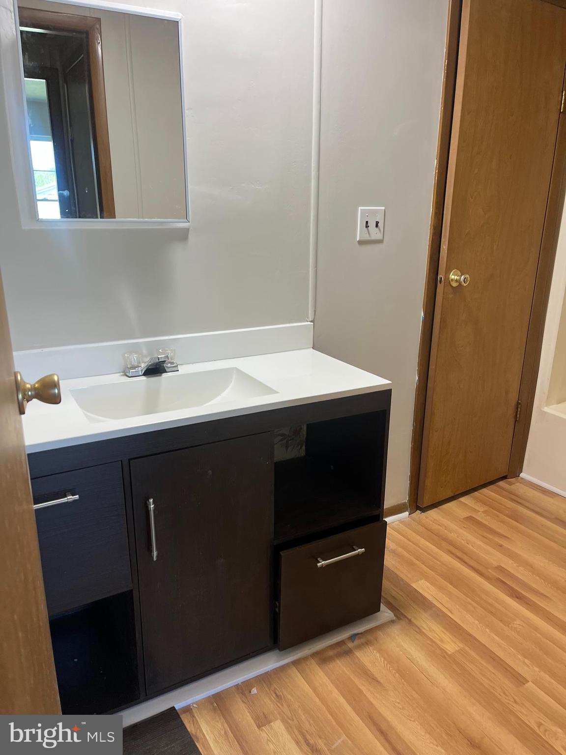 369 Ivey Creek Road Lancaster, VA 22503 - Photo 25 of 31 a bedroom with a sink and a mirror