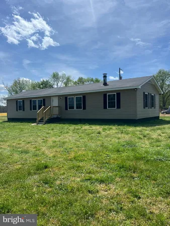 a view of a house with a backyard and a garden