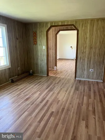 a view of a room with wooden floor