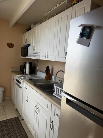 a kitchen with a sink a stove and cabinets