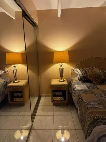 a bedroom with a bed and a lamp