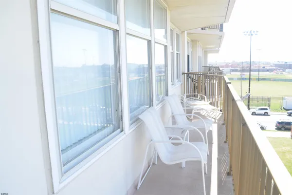 a view of a balcony and dining room