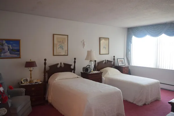 a bedroom with furniture and a window