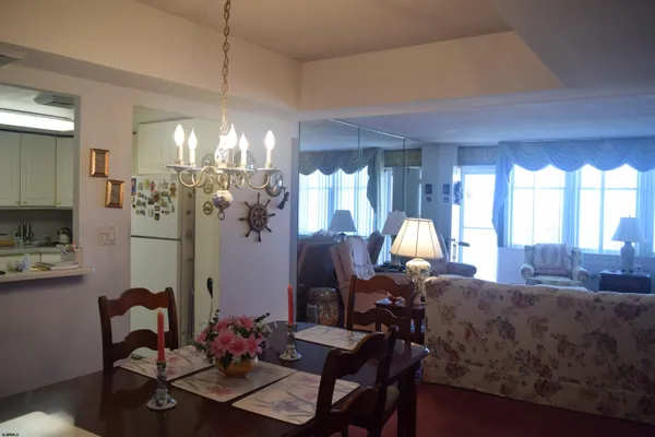 a living room with furniture fireplace and large windows