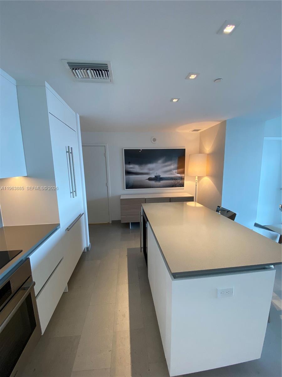 88 Southwest 7th Street, Unit 1904 Miami, FL 33130 - Photo 6 of 33 a spacious bedroom with a bed and a flat screen tv