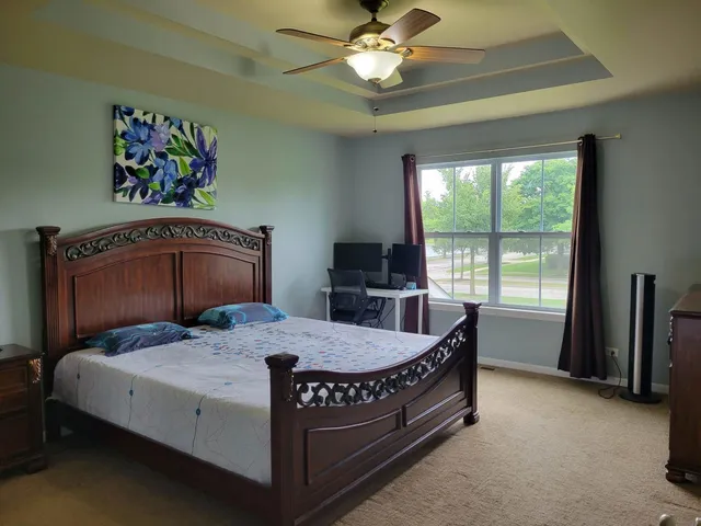 a bedroom with a bed and a chandelier