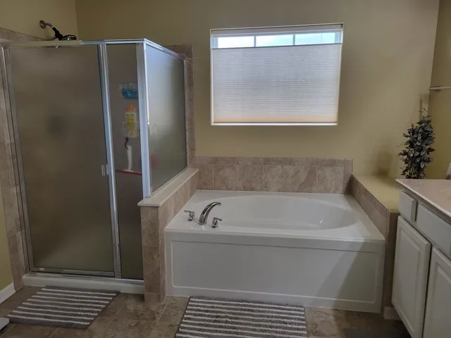 a bathroom with a bathtub and shower