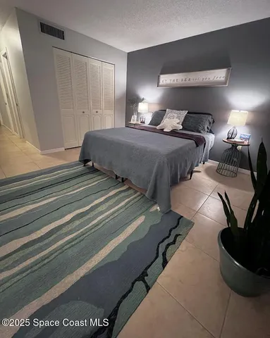 a bedroom with two beds and a lamp