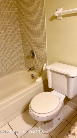 a white toilet and tub sitting next to a bathroom sink