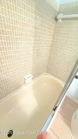 a bathroom with a bathtub and shower