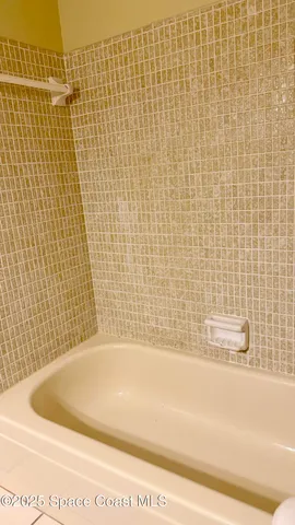 a front view of a house with a yard and palm trees