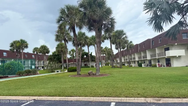 a view of a patio with chair and tables back yard of the house