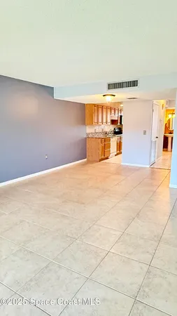 a view of a livingroom with a dishwasher and cabinets