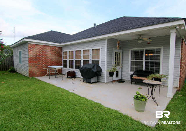 7263 Highpointe Place East Daphne, AL 36527 - Photo 7 of 22 The back patio features a covered and uncovered section overlooking a fenced yard!