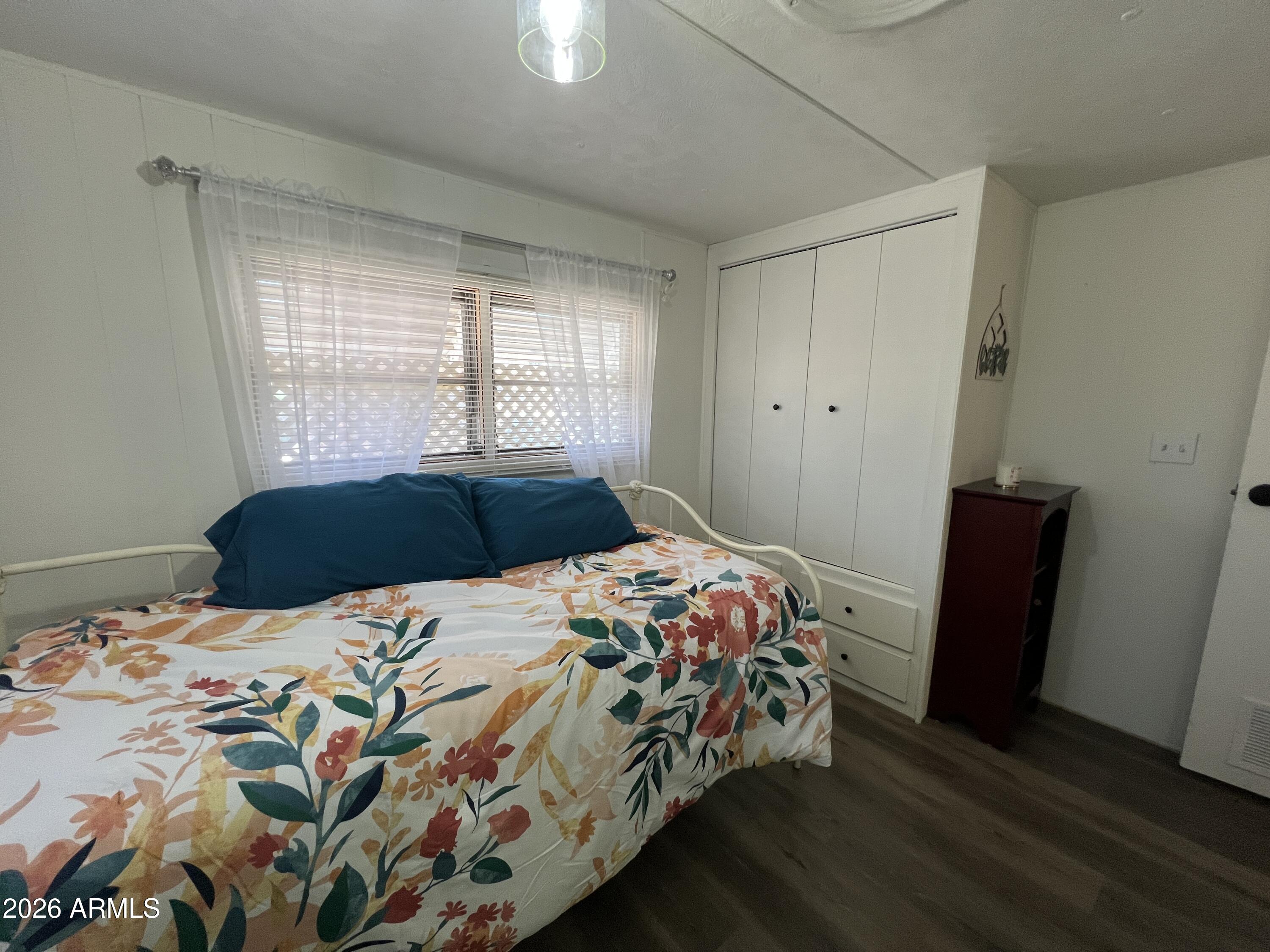 19225 North Cave Creek Road, Unit 40 Phoenix, AZ 85024 - Photo 5 of 21 a bedroom with a bed and a window