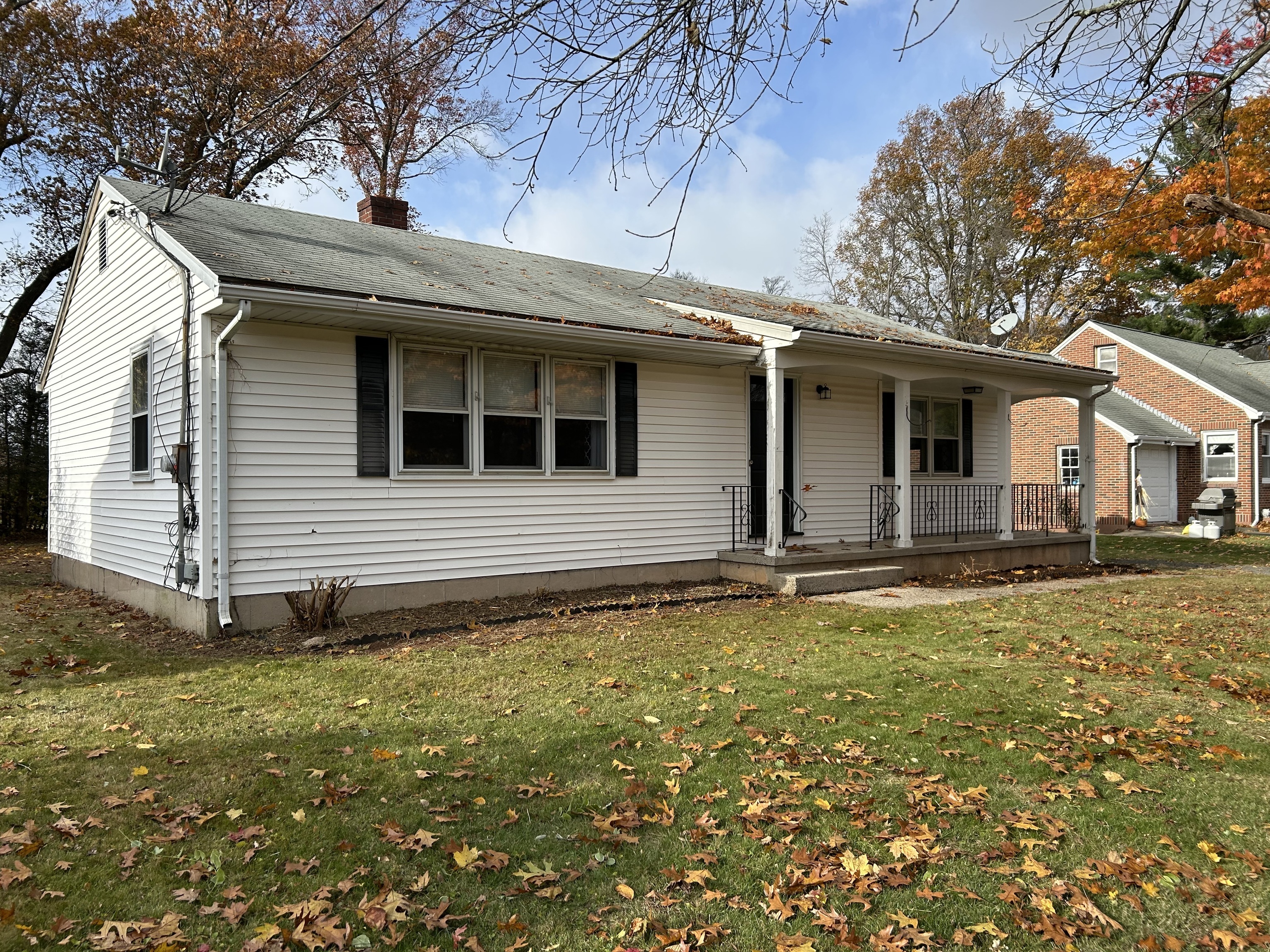 a backyard of a house with table and chairs