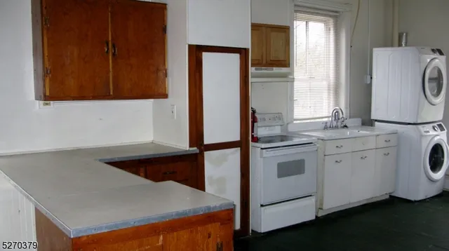 a kitchen with a refrigerator sink and cabinets