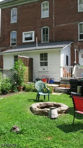 a front view of house with yard and outdoor seating