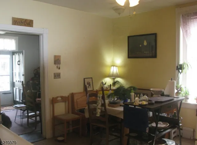 a view of a dining room with furniture and window
