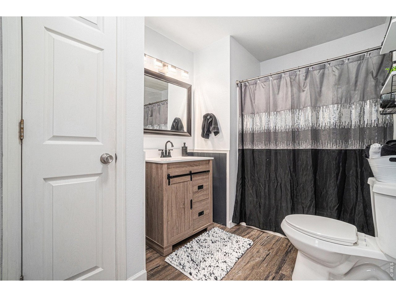 2601 Alpine Avenue Greeley, CO 80631 - Photo 13 of 20 a bathroom with a sink a toilet a mirror and shower