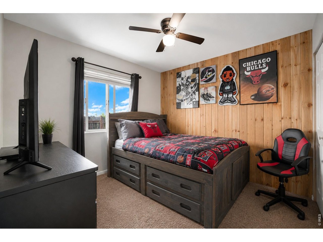 2601 Alpine Avenue Greeley, CO 80631 - Photo 15 of 20 a bedroom with a bed and a chandelier
