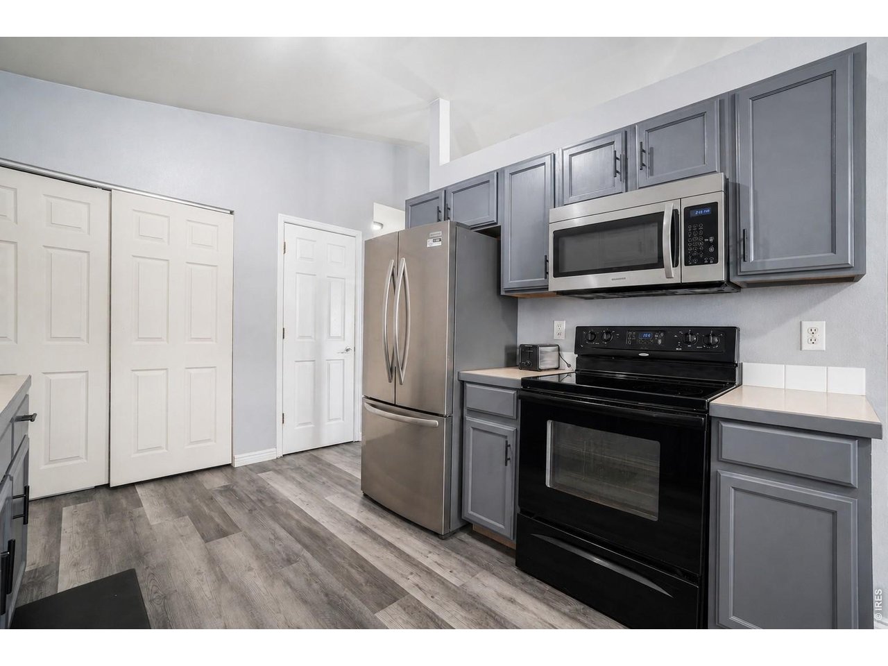 2601 Alpine Avenue Greeley, CO 80631 - Photo 9 of 20 a kitchen with stainless steel appliances granite countertop a stove a microwave and a refrigerator