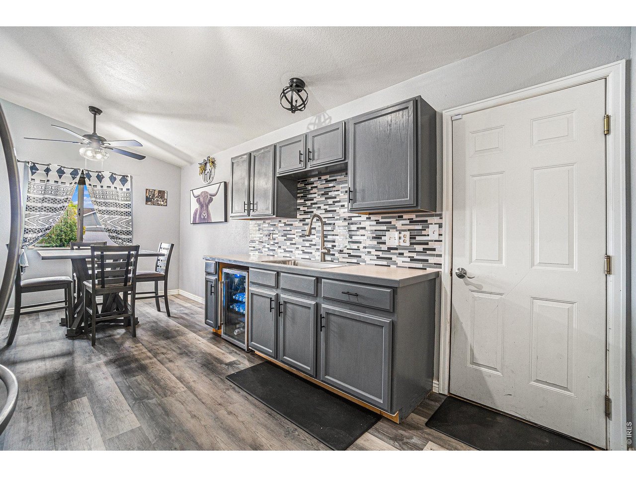 2601 Alpine Avenue Greeley, CO 80631 - Photo 10 of 20 a kitchen with stainless steel appliances kitchen island granite countertop a refrigerator and cabinets