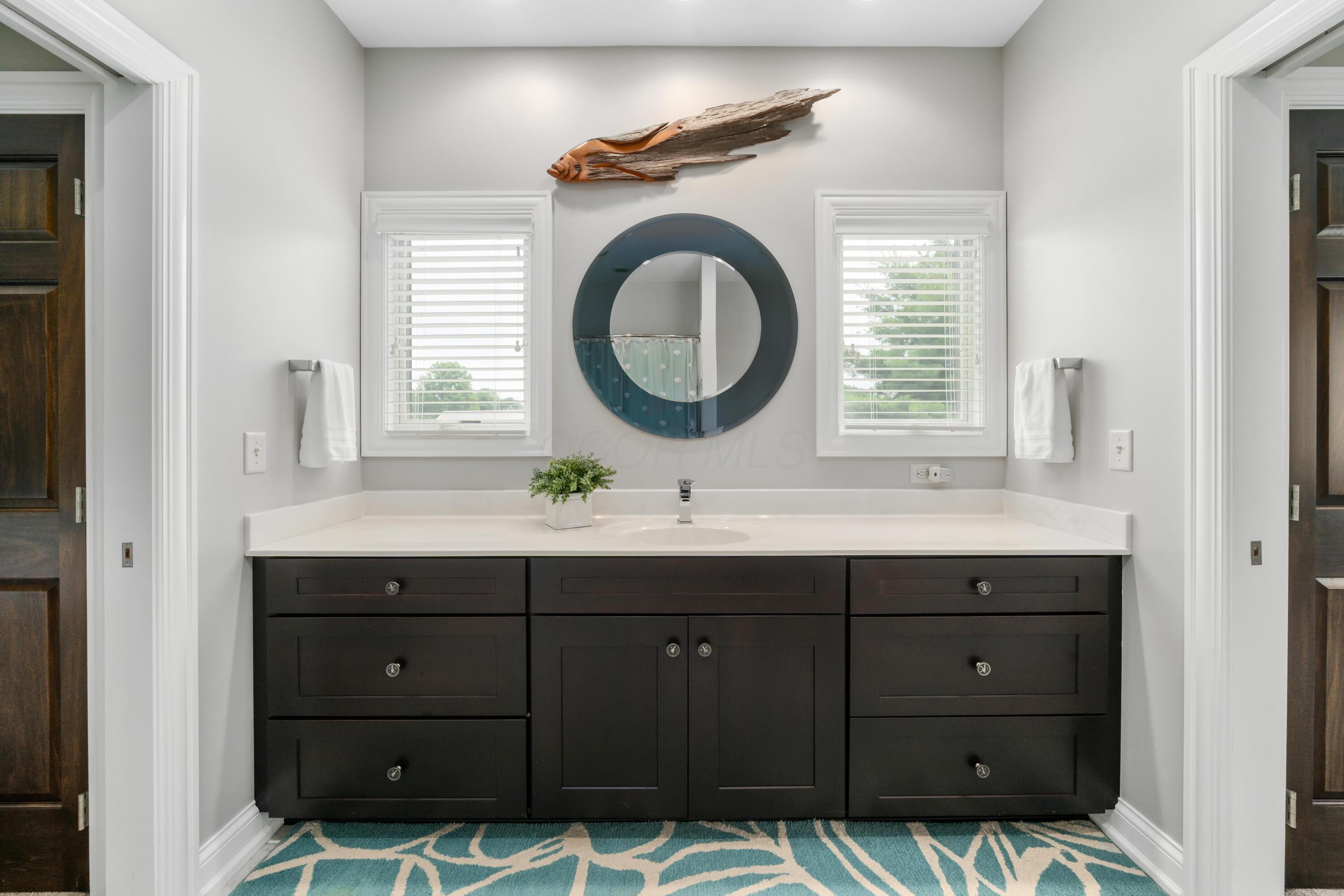 4640 Maynard Road Delaware, OH 43015 - Photo 50 of 91 Double vanity featuring a dark wood cabinet, white countertop, and integrated sink