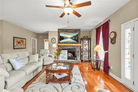a living room with furniture a rug and a lamp
