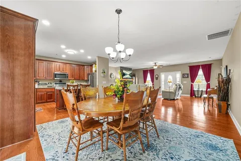 a dining room with furniture a rug and a chandelier