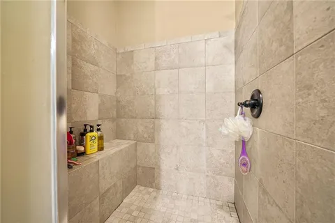 a bathroom with a granite countertop sink a mirror and a shower