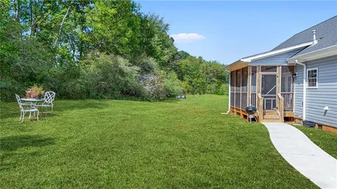 a front view of a house with a yard and ocean view
