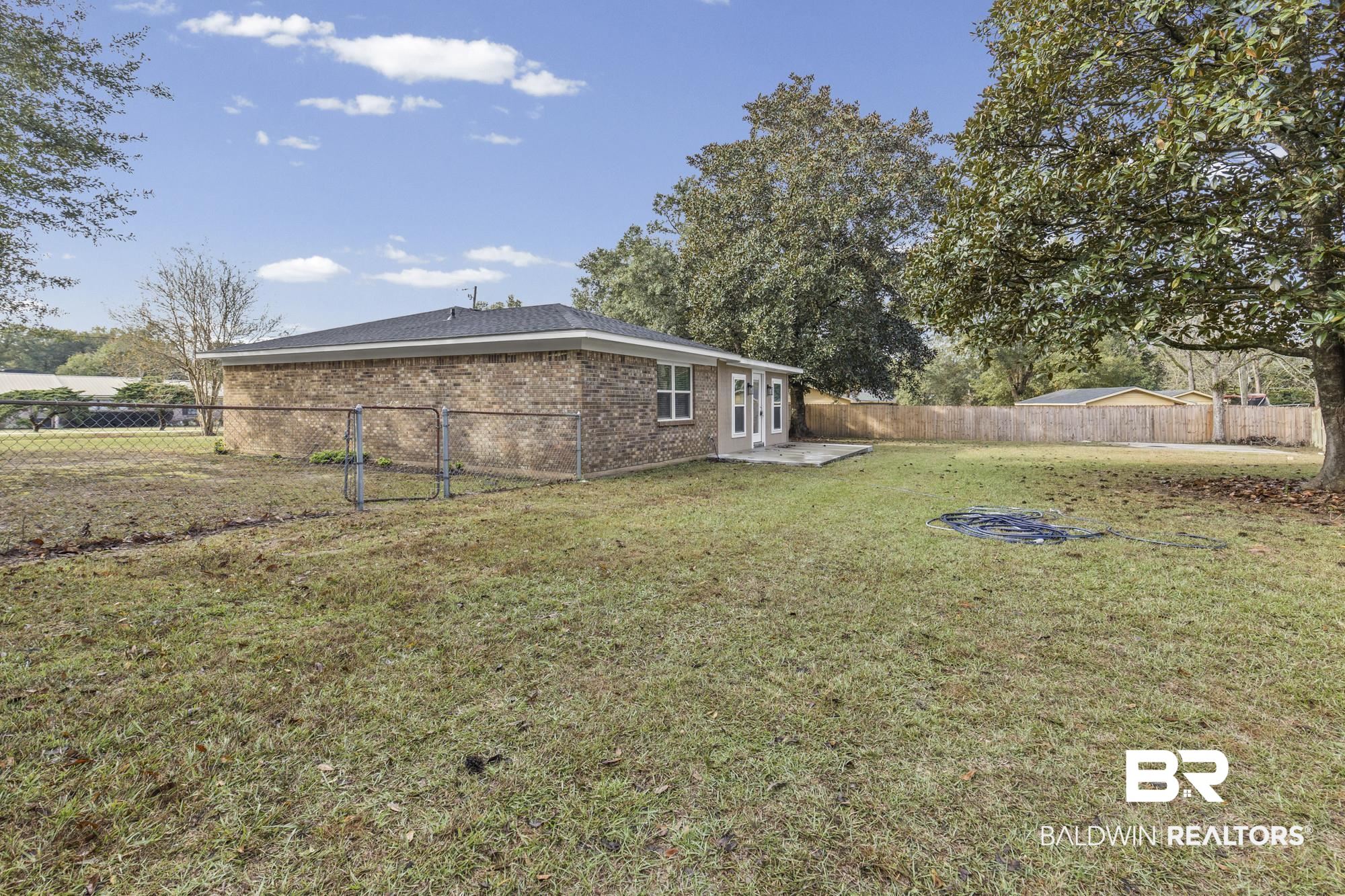 3041 Pretty Branch Drive East Mobile, AL 36618 - Photo 19 of 20 Fenced backyard with a patio area