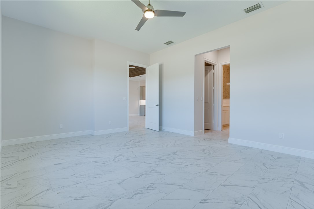 1805 Bridgepointe Circle, Unit 2 Vero Beach, FL 32967 - Photo 13 of 28 an empty room with a ceiling fan and a window