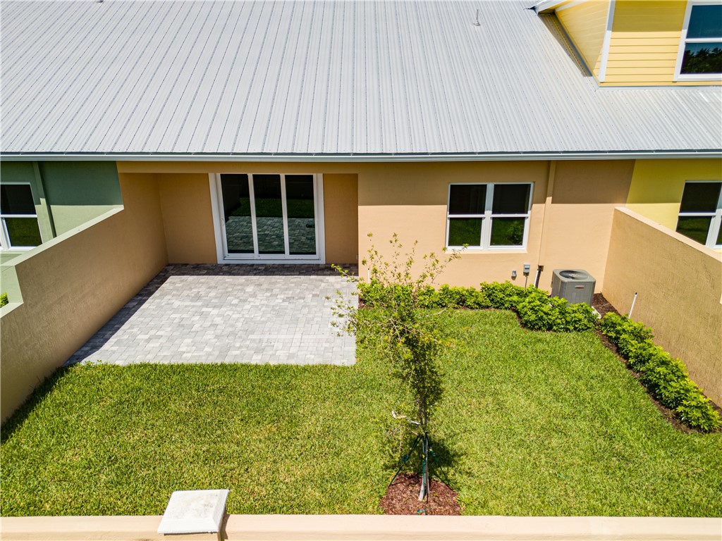 1805 Bridgepointe Circle, Unit 2 Vero Beach, FL 32967 - Photo 19 of 28 a front view of a house with garden
