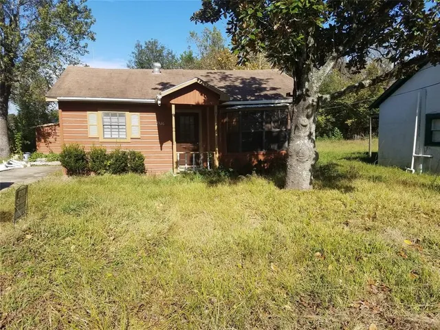 a view of house with yard and sitting area