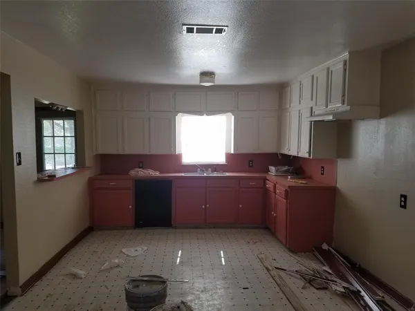 a room with a cabinets and window