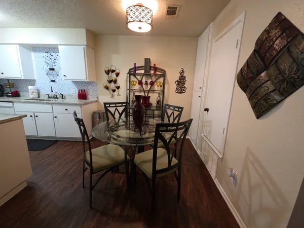 a view of a dining room with furniture and wooden floor